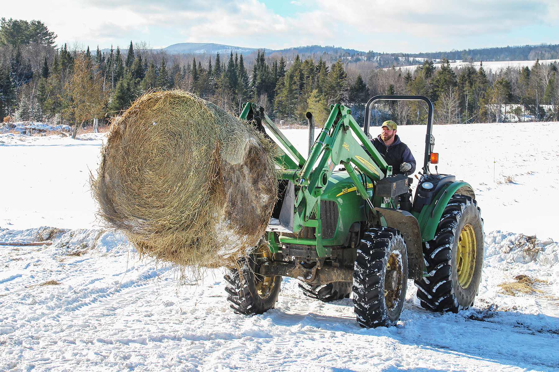 Ben moving hay with tractor